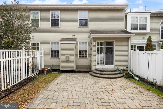 a view of a house with a small yard and a chair