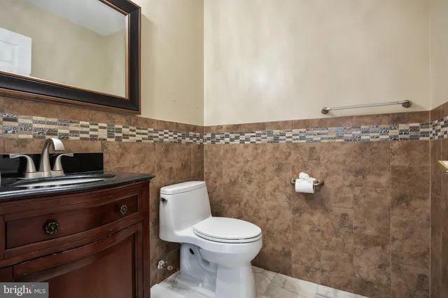 a bathroom with a toilet a sink and mirror