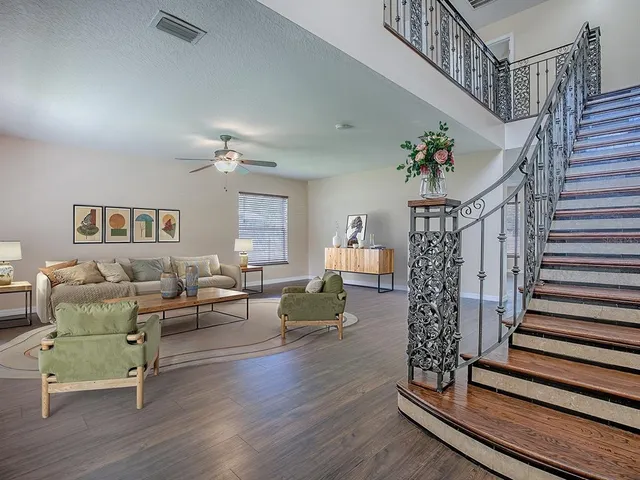 a living room with furniture and wooden floor