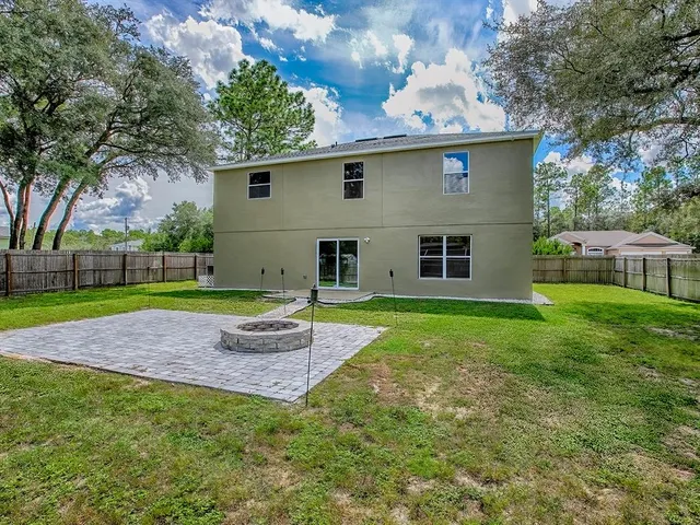 an empty room with a ceiling fan and window