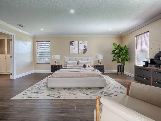a spacious bedroom with a large bed and a couch