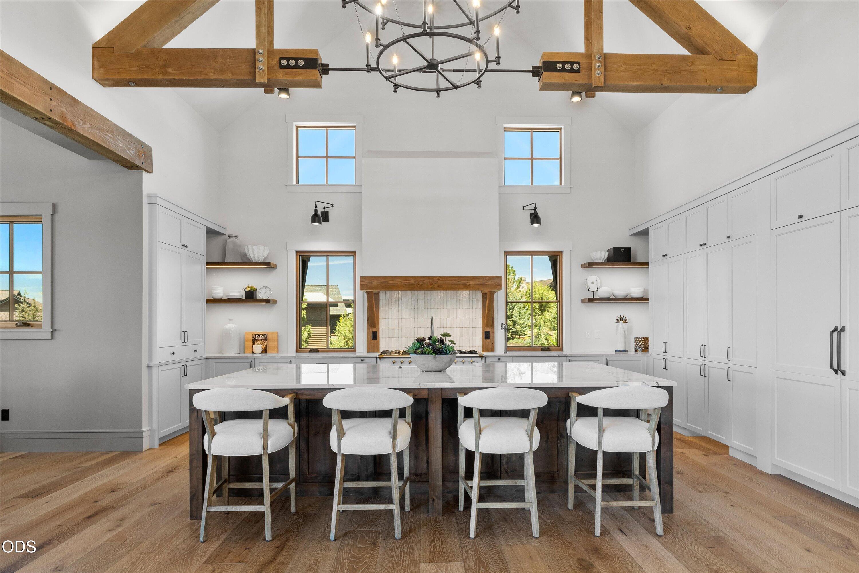 16215 South W Vaqueros Way Powell Butte, OR 97753 - Photo 10 of 48 Living flows into a welcoming kitchen with high ceilings, natural light, oversized island and bar seating