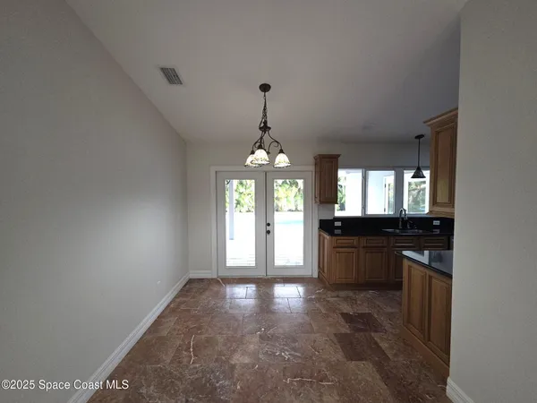 a large kitchen with granite countertop a stove top oven a sink and dishwasher