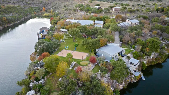 a living room with furniture kitchen view and a chandelier