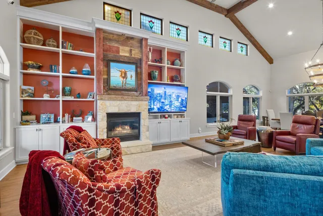 a dining room with wooden floor a chandelier a wooden table and chairs