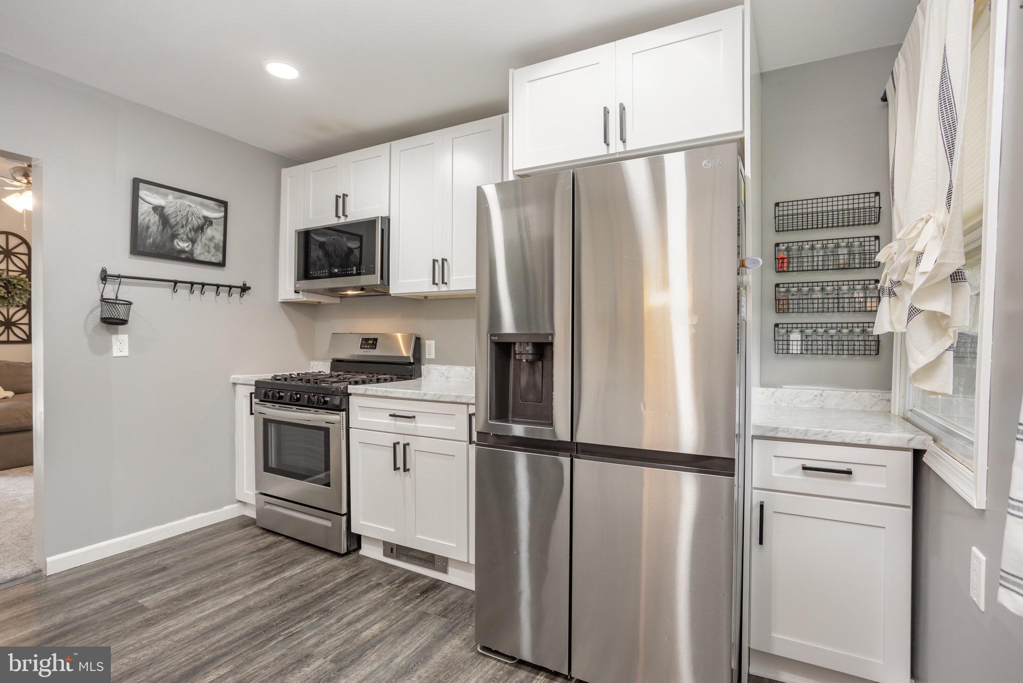 33 Honeycomb Road Middle River, MD 21220 - Photo 14 of 29 a kitchen with stainless steel appliances a refrigerator stove and microwave