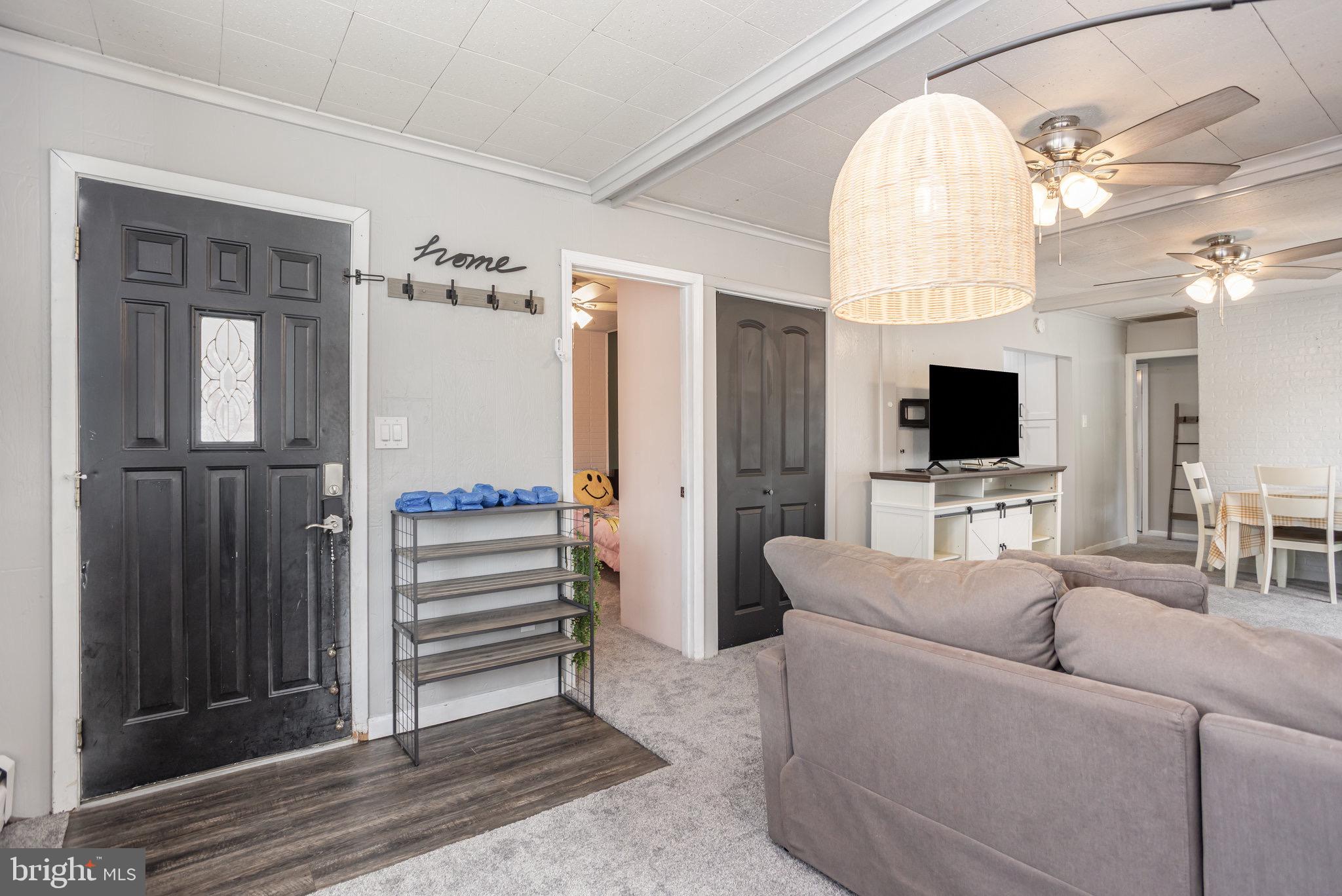 33 Honeycomb Road Middle River, MD 21220 - Photo 7 of 29 a living room with furniture a flat screen tv and a fireplace
