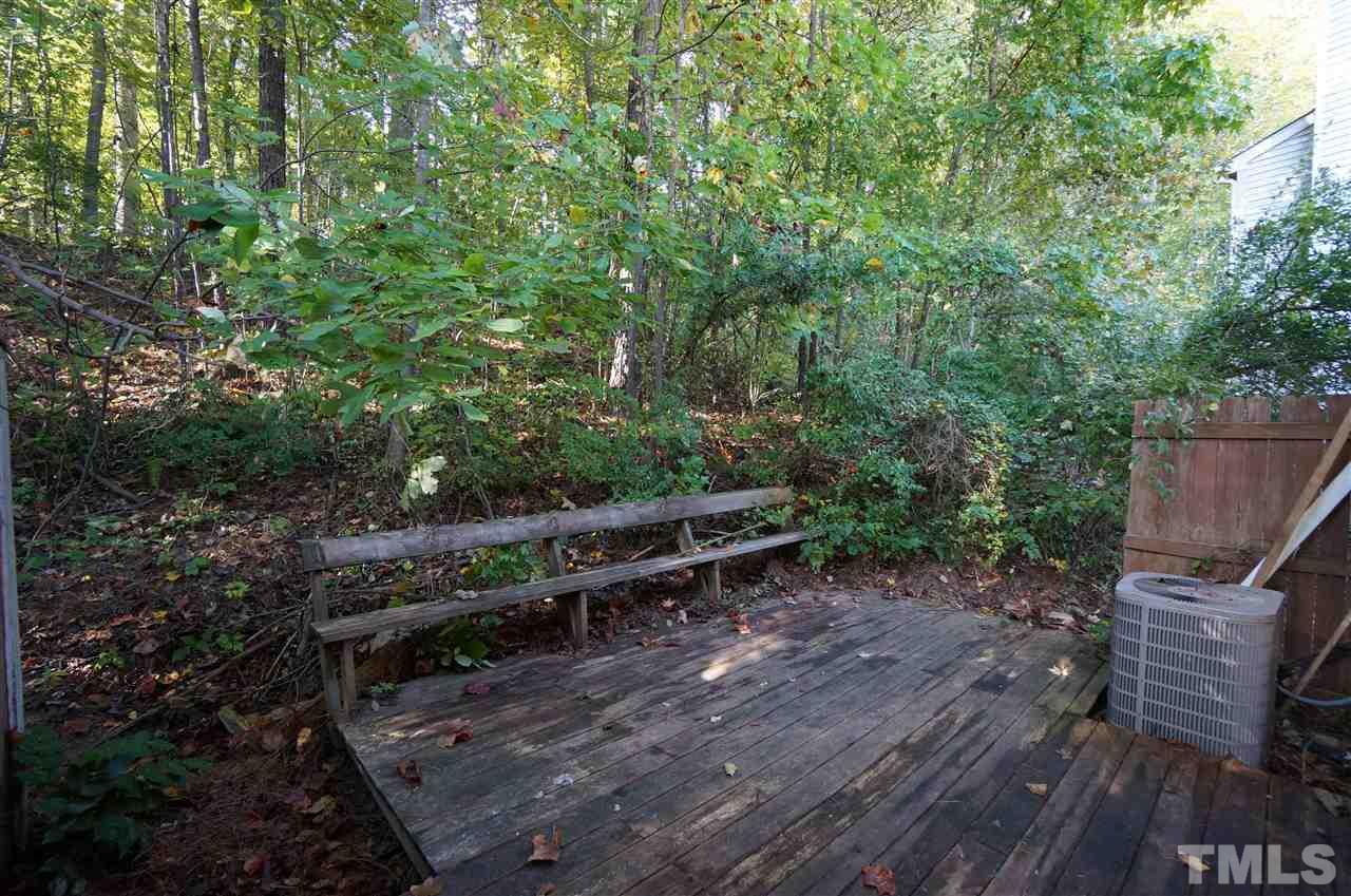 1137 Villa Green Court Raleigh, NC 27612 - Photo 13 of 14 Large back deck sits quietly among the shade of the trees.