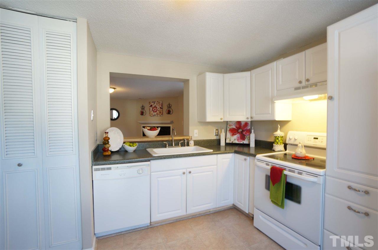 1137 Villa Green Court Raleigh, NC 27612 - Photo 3 of 14 Bright & spacious kitchen in warm & inviting, complete with breakfast area & lots of cabinet storage space. Cut out window keeps with conversation & activity flow.