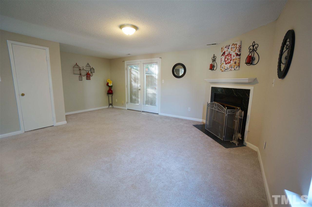 1137 Villa Green Court Raleigh, NC 27612 - Photo 5 of 14 Bright & Spacious Living room has double doors that lead to large back deck & fireplace perfect for the approaching winter months.