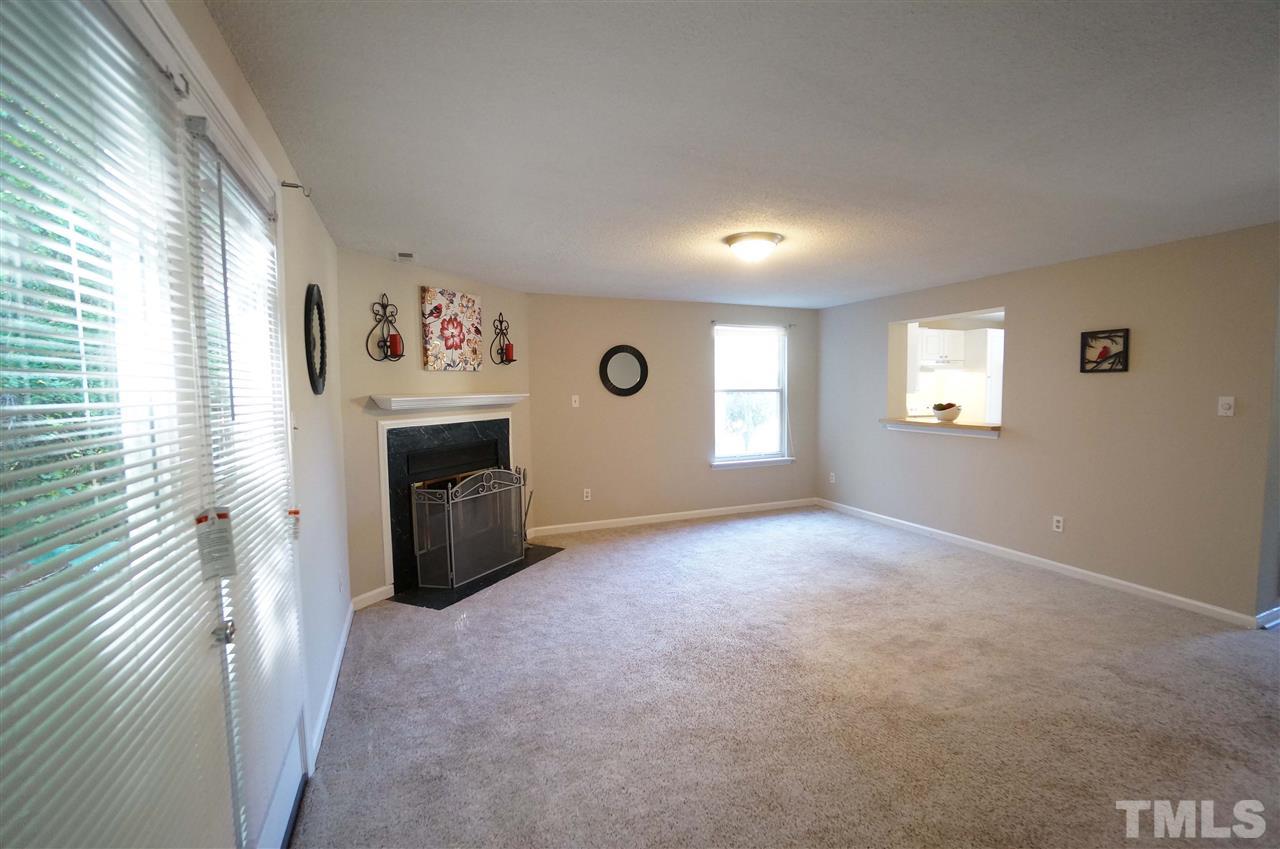 1137 Villa Green Court Raleigh, NC 27612 - Photo 6 of 14 Bright & Spacious Living room has double doors that lead to large back deck & fireplace perfect for the approaching winter months.