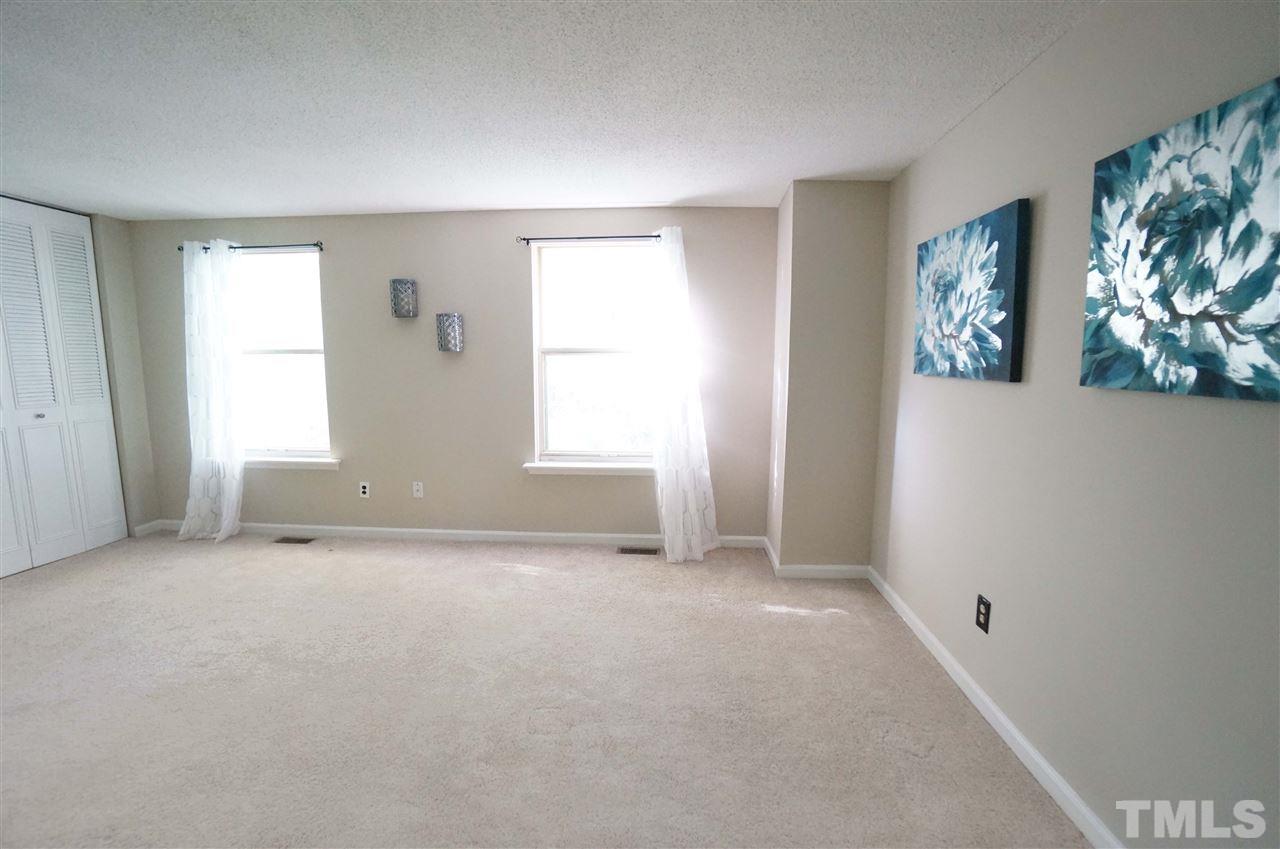 1137 Villa Green Court Raleigh, NC 27612 - Photo 8 of 14 Spacious Master has beautiful natural lighting that showers the space in a soft glow. Windows look out over the wooded lot for added beauty & privacy. Large closets for added storage.