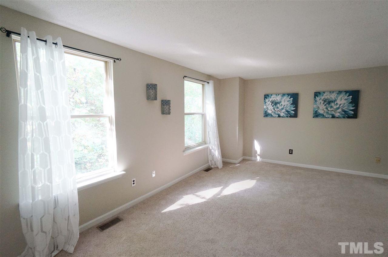 1137 Villa Green Court Raleigh, NC 27612 - Photo 9 of 14 Spacious Master has beautiful natural lighting that showers the space in a soft glow. Windows look out over the wooded lot for added beauty & privacy. Large closets for added storage.