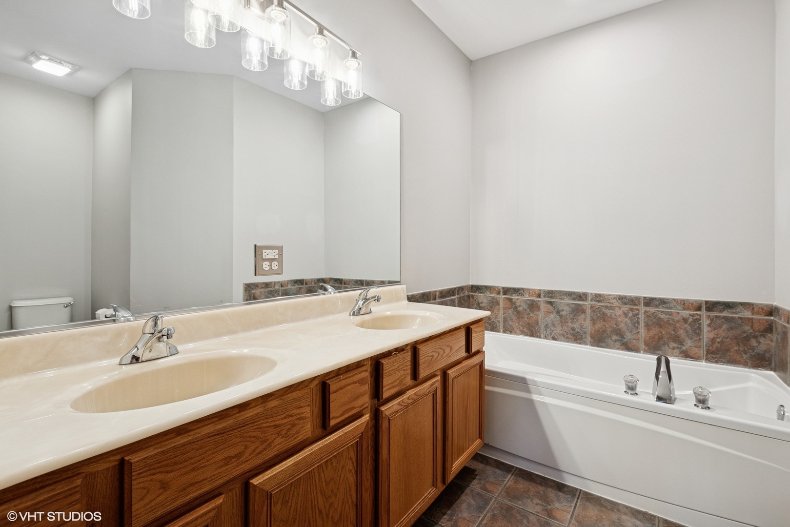 54 Andover Circle Northbrook, IL 60062 - Photo 14 of 26 a bathroom with a tub double sink and mirror