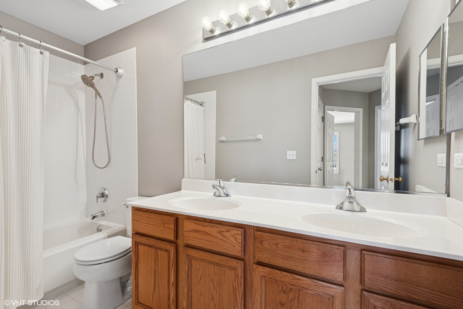 54 Andover Circle Northbrook, IL 60062 - Photo 17 of 26 a bathroom with a double vanity sink toilet mirror and shower