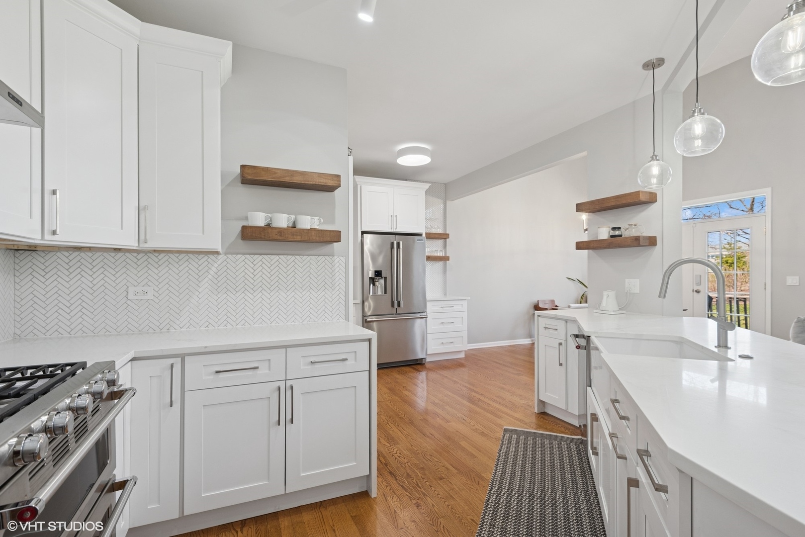 54 Andover Circle Northbrook, IL 60062 - Photo 9 of 26 a kitchen with white cabinets and stainless steel appliances