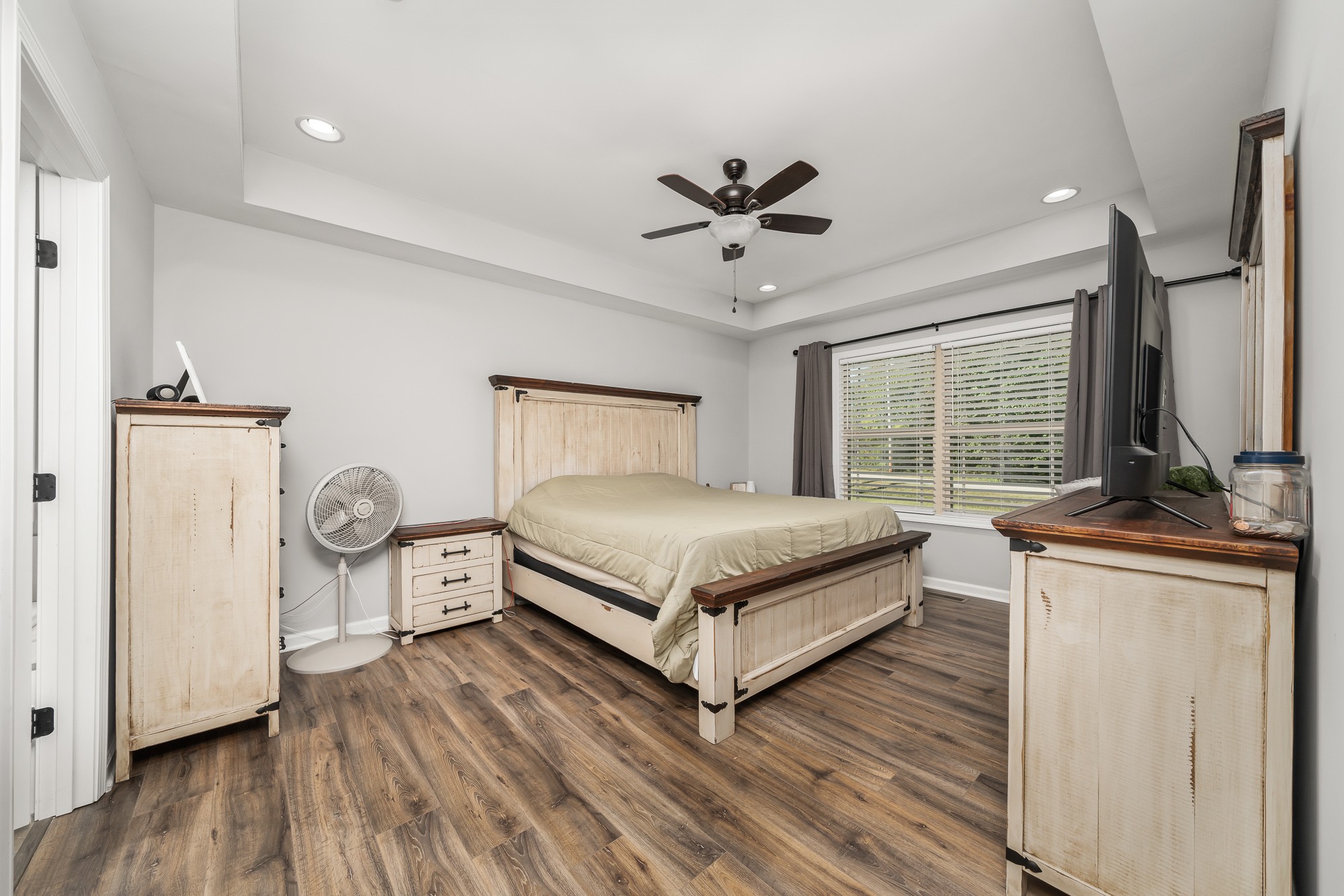 8606 Fredonia Road Manchester, TN 37355 - Photo 17 of 29 a bedroom with a bed a dresser and wooden floor