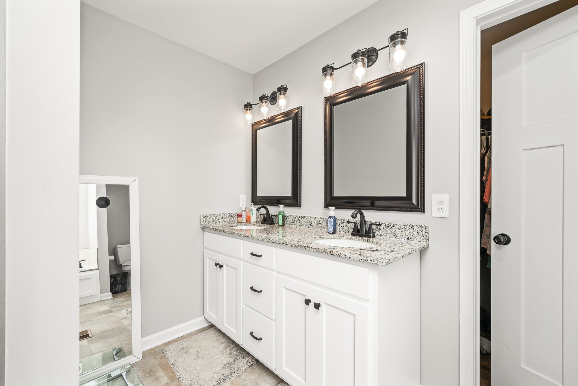 8606 Fredonia Road Manchester, TN 37355 - Photo 20 of 29 a bathroom with a double vanity sink and mirror