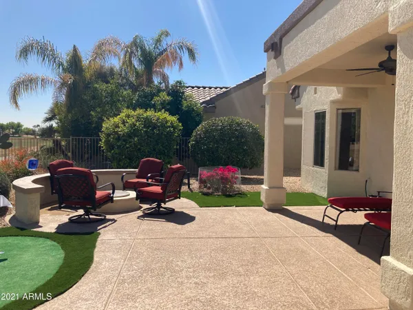 a backyard of a house with yard fire pit table and chairs