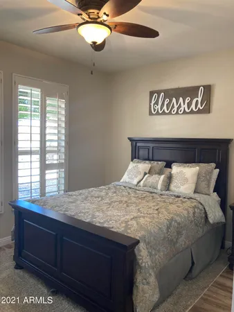a bedroom with a bed and cabinet