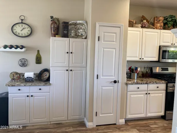 a view of cabinets and window with wooden floor