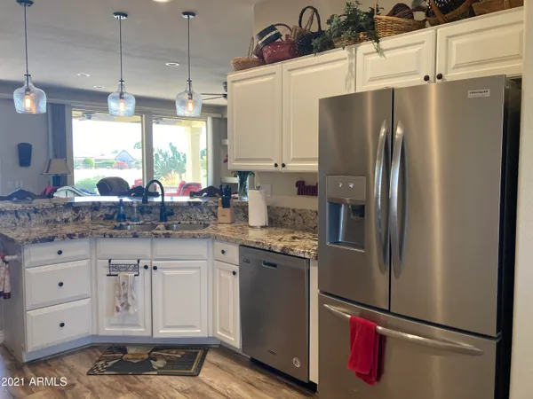 a kitchen with stainless steel appliances a refrigerator sink and cabinets