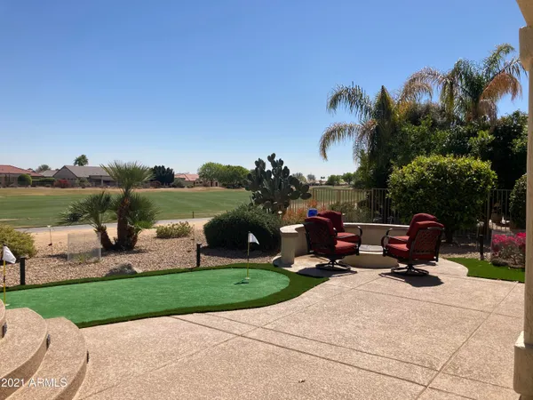a backyard of a house with table and chairs