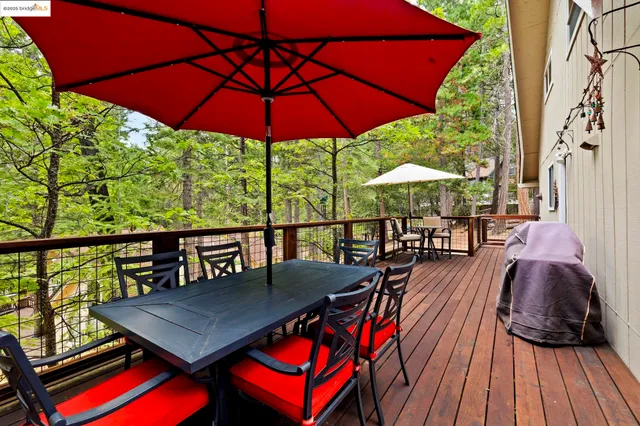 a view of a balcony with chairs and wooden floor