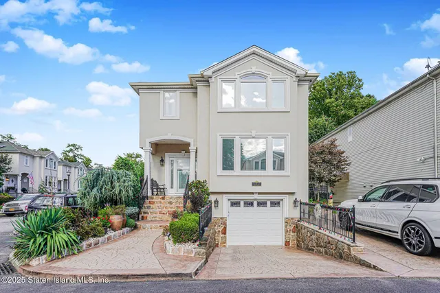 a front view of a house with a garden