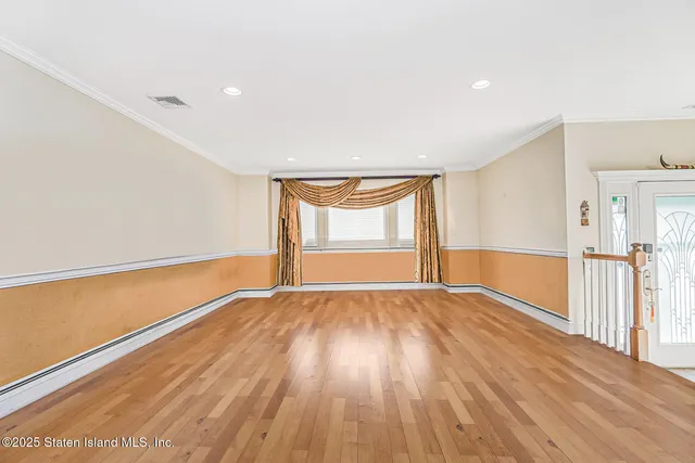 a living room with furniture a chandelier and a dining table