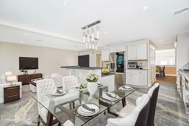 a view of kitchen with wooden cabinets and electronic appliances