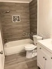 a bathroom with a toilet a sink and bathtub