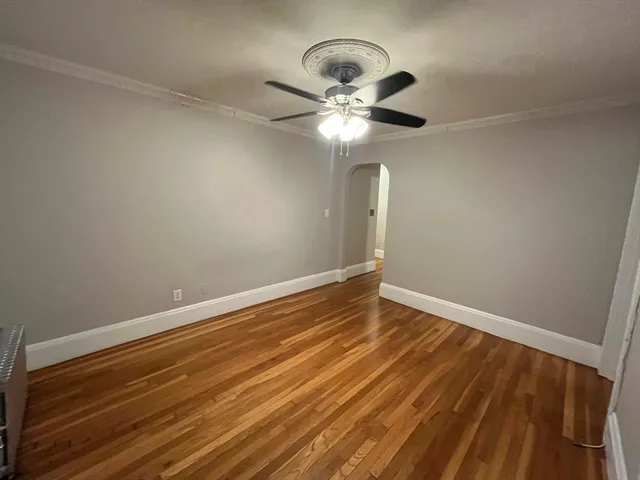 a view of room with wooden floor and ceiling fan