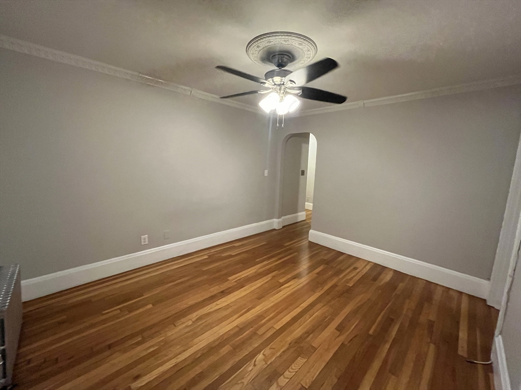 99 Franklin Street, Unit 2 Lynn, MA 01902 - Photo 3 of 4 a view of room with wooden floor and ceiling fan