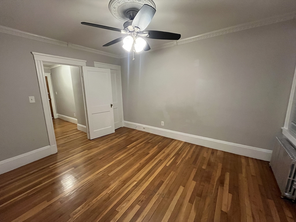 99 Franklin Street, Unit 2 Lynn, MA 01902 - Photo 4 of 4 wooden floor in an empty room with a window
