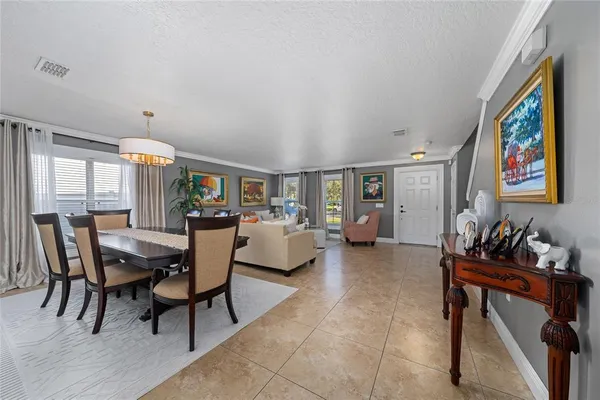 a living room with furniture a rug and a flat screen tv