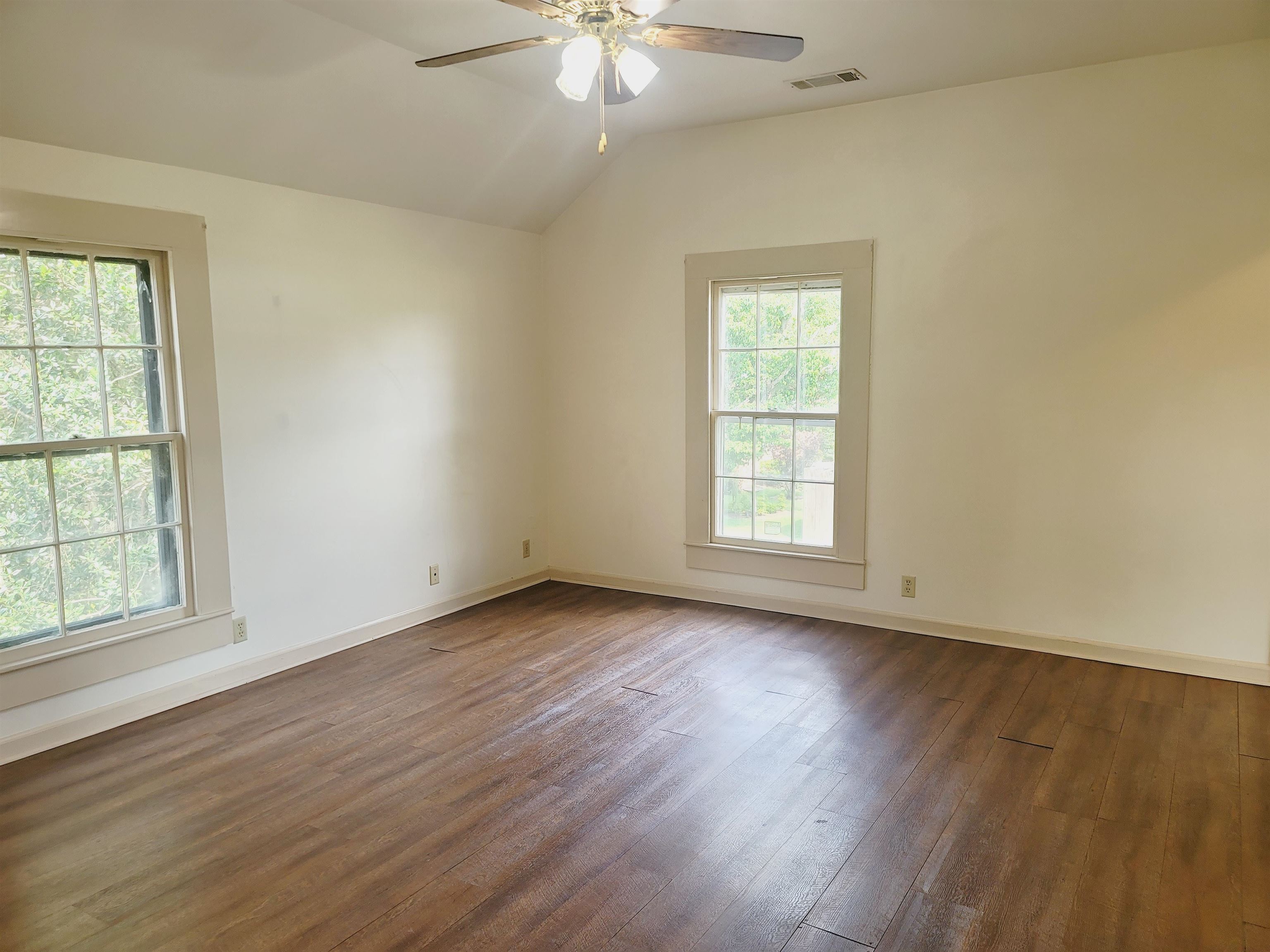 302 Jefferson Street, Unit 2 Springfield, GA 31329 - Photo 14 of 23 a view of an empty room with wooden floor and a window