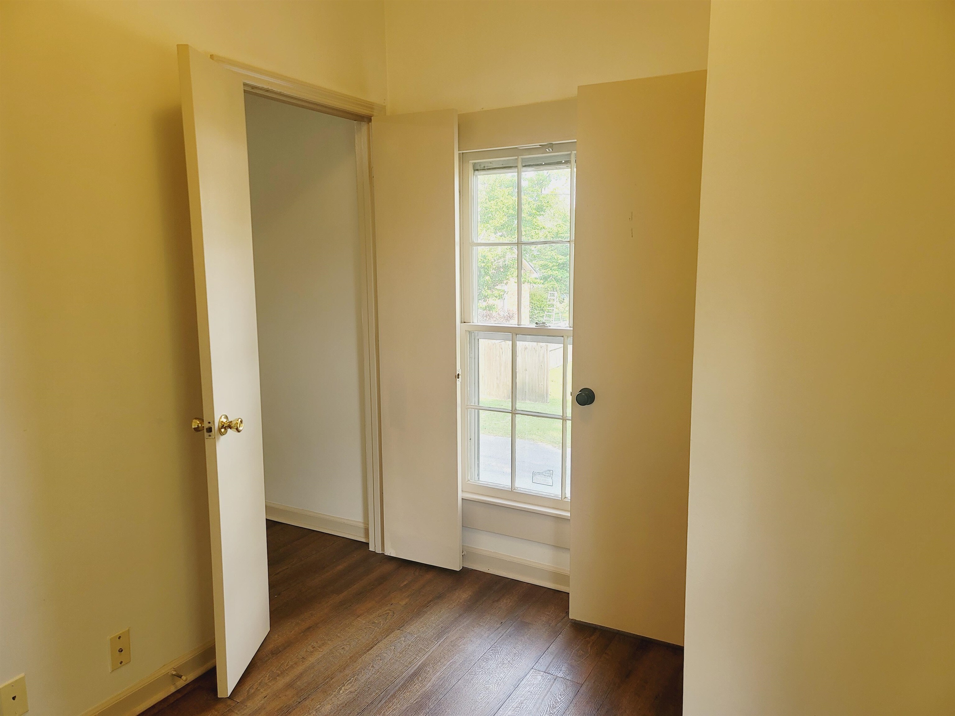 302 Jefferson Street, Unit 2 Springfield, GA 31329 - Photo 20 of 23 a view of an empty room with wooden floor and a window