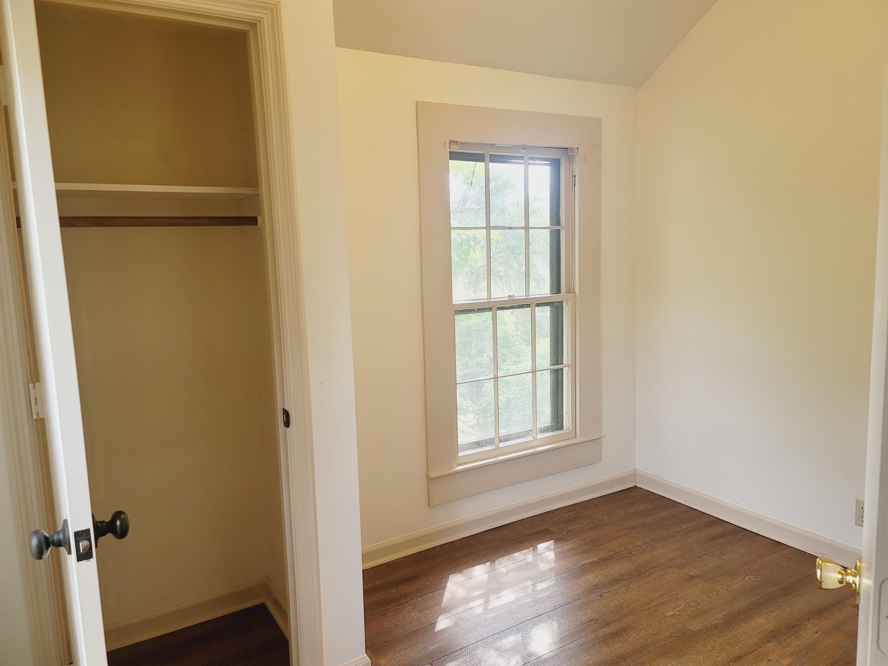 302 Jefferson Street, Unit 2 Springfield, GA 31329 - Photo 22 of 23 an empty room with wooden floor closet and windows