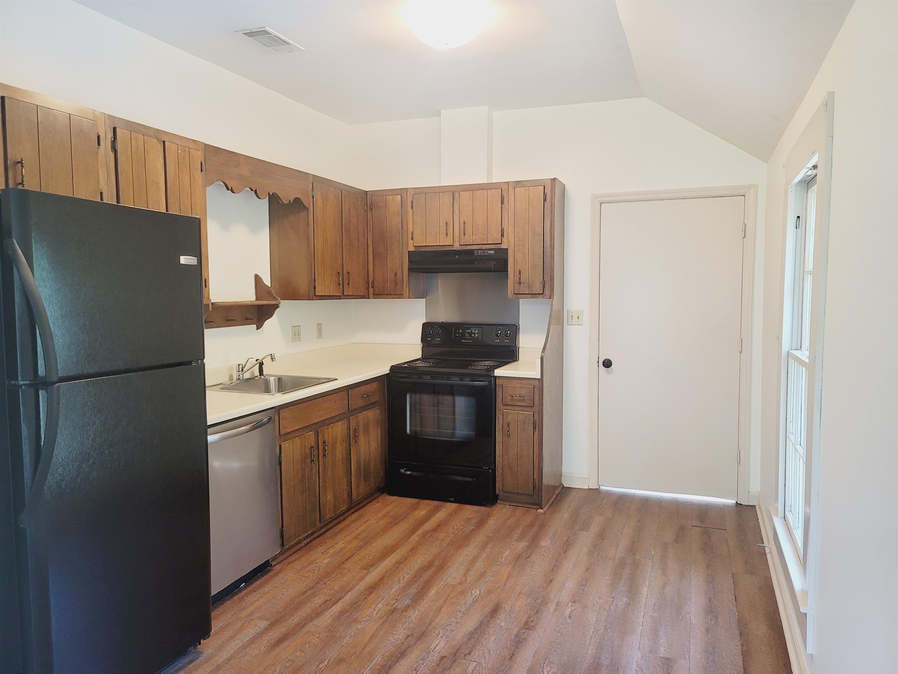302 Jefferson Street, Unit 2 Springfield, GA 31329 - Photo 9 of 23 a kitchen with a refrigerator and a stove top oven