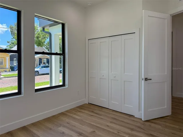 a view of entryway and hall with wooden floor