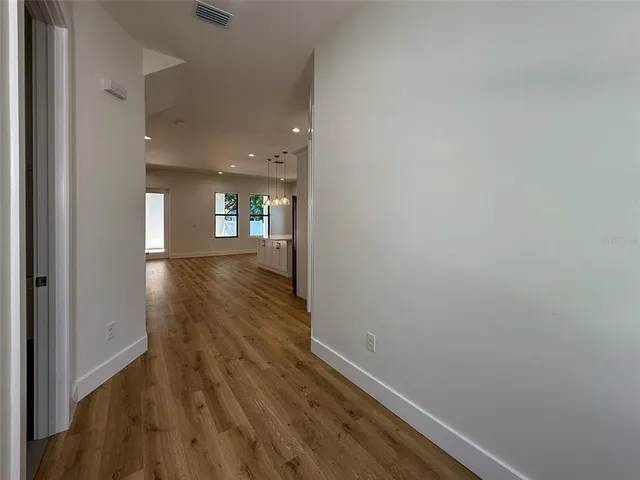 a view of a hallway view with wooden floor and staircase