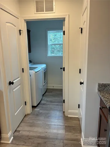 a view of hallway with wooden floor
