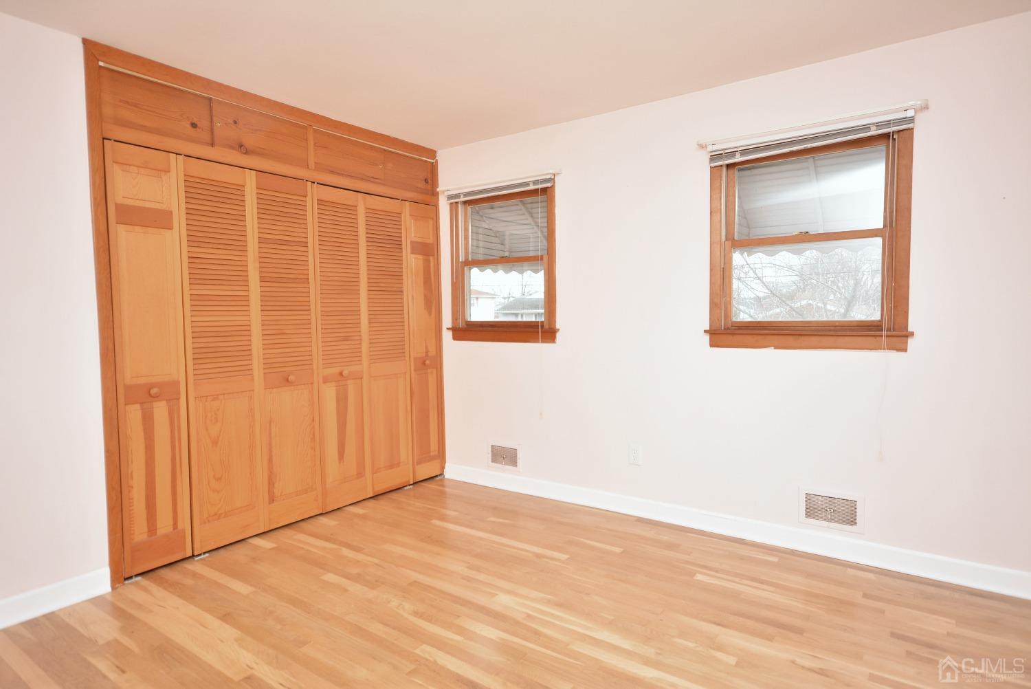 105 Brentwood Road Raritan, NJ 08869 - Photo 23 of 33 an empty room with wooden floor and windows