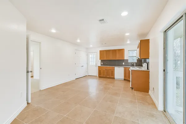 a view of a kitchen with a sink and a refrigerator