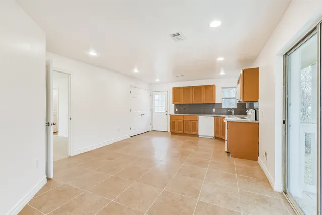 a view of a kitchen with a sink and a refrigerator