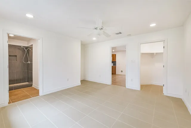 a view of an empty room with glass door