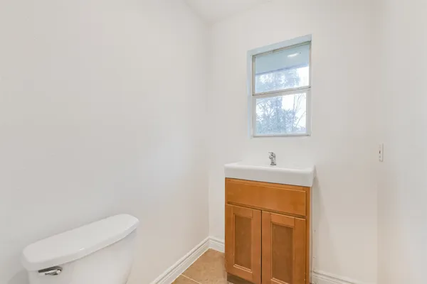 a bathroom with a toilet a sink and mirror