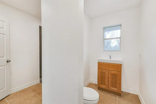 a white toilet sitting next to a bathroom sink