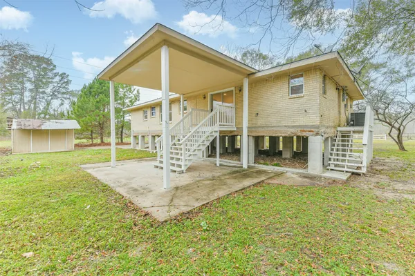 a view of a house with a yard and sitting area